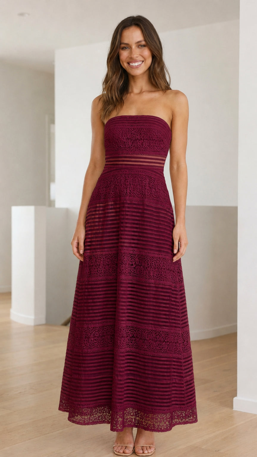 Model wearing burgundy strapless lace maxi dress