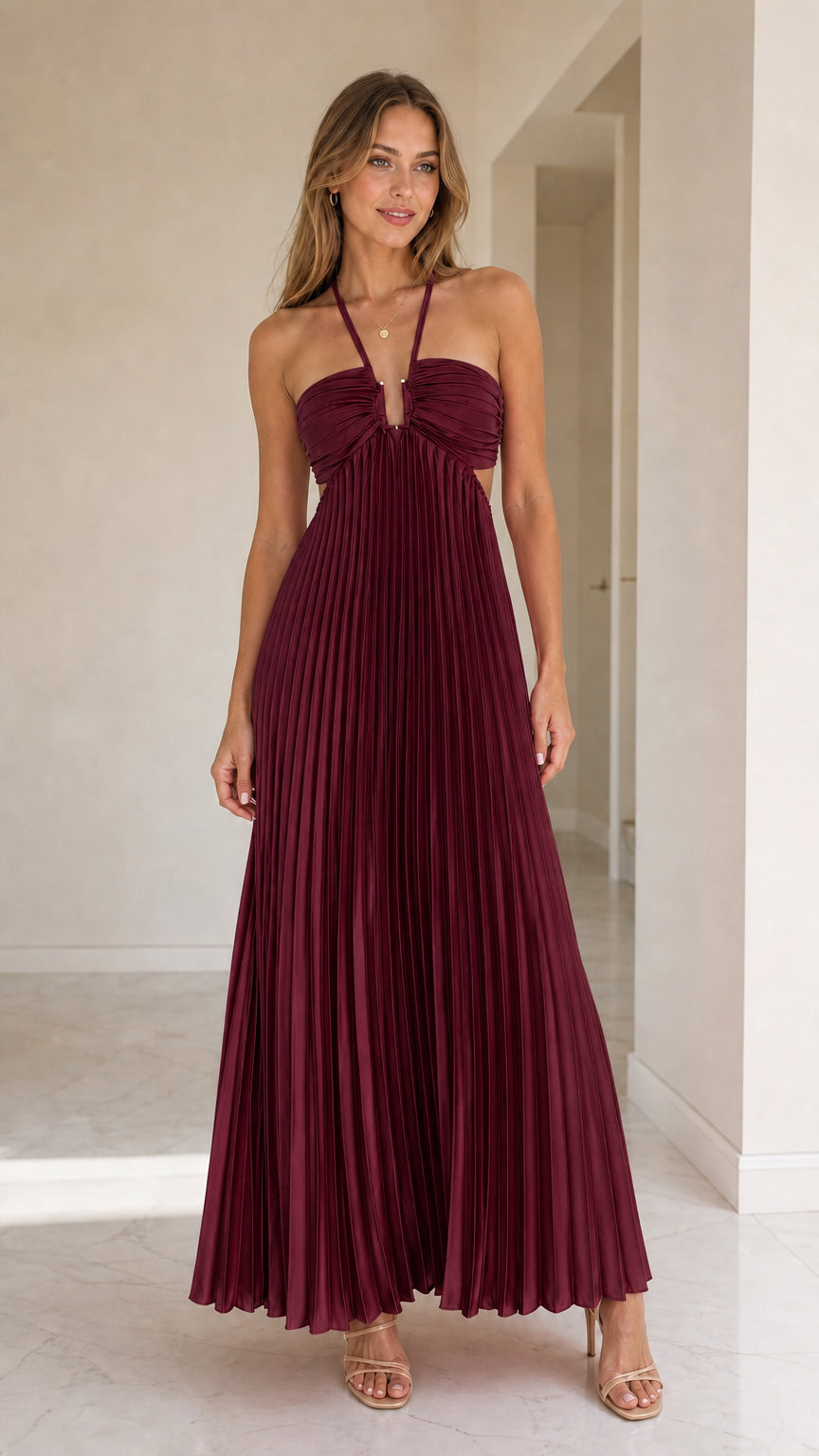 Model wearing burgundy halter pleated maxi dress