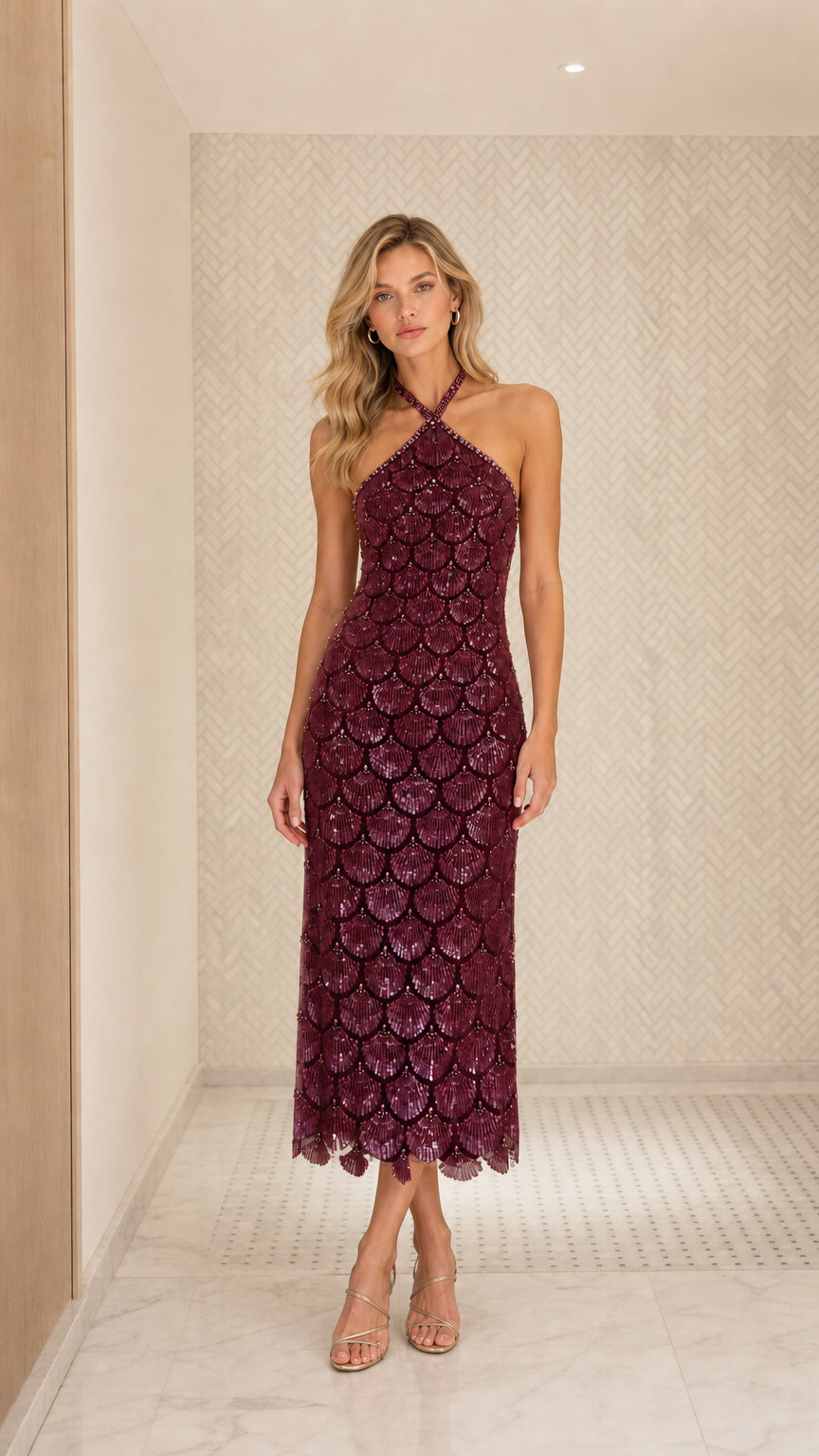 Front view of model wearing burgundy sequin halter midi dress