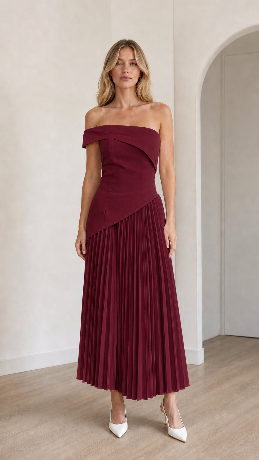 Model wearing burgundy off-shoulder asymmetric pleated midi dress