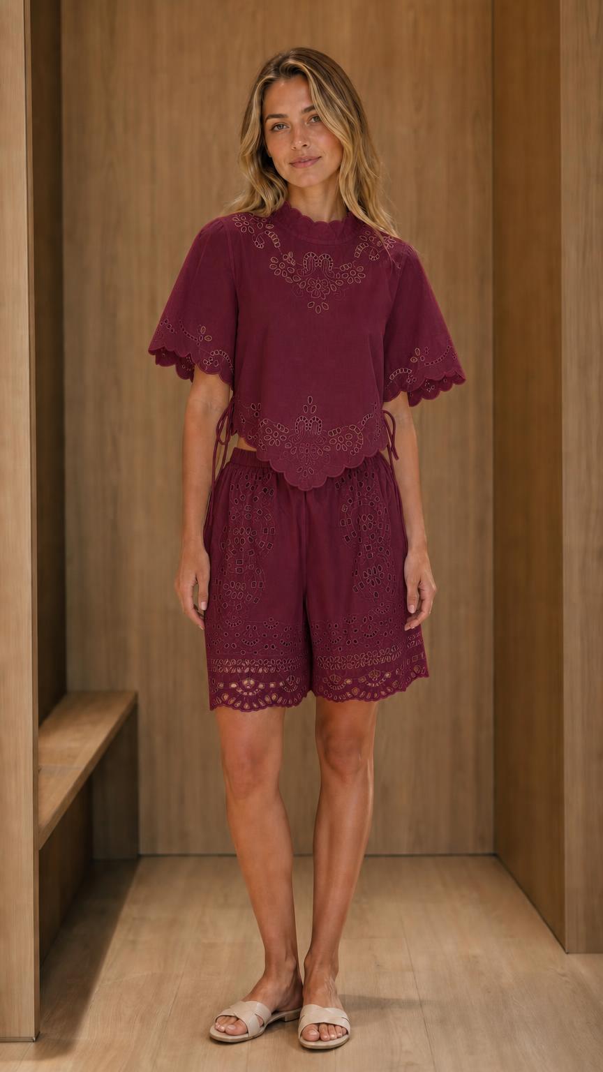 Model wearing burgundy eyelet embroidered top and shorts set