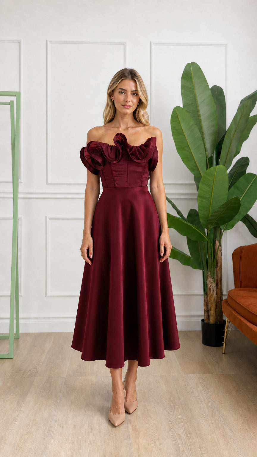 Front view of woman wearing burgundy off-shoulder ruffle corset midi dress