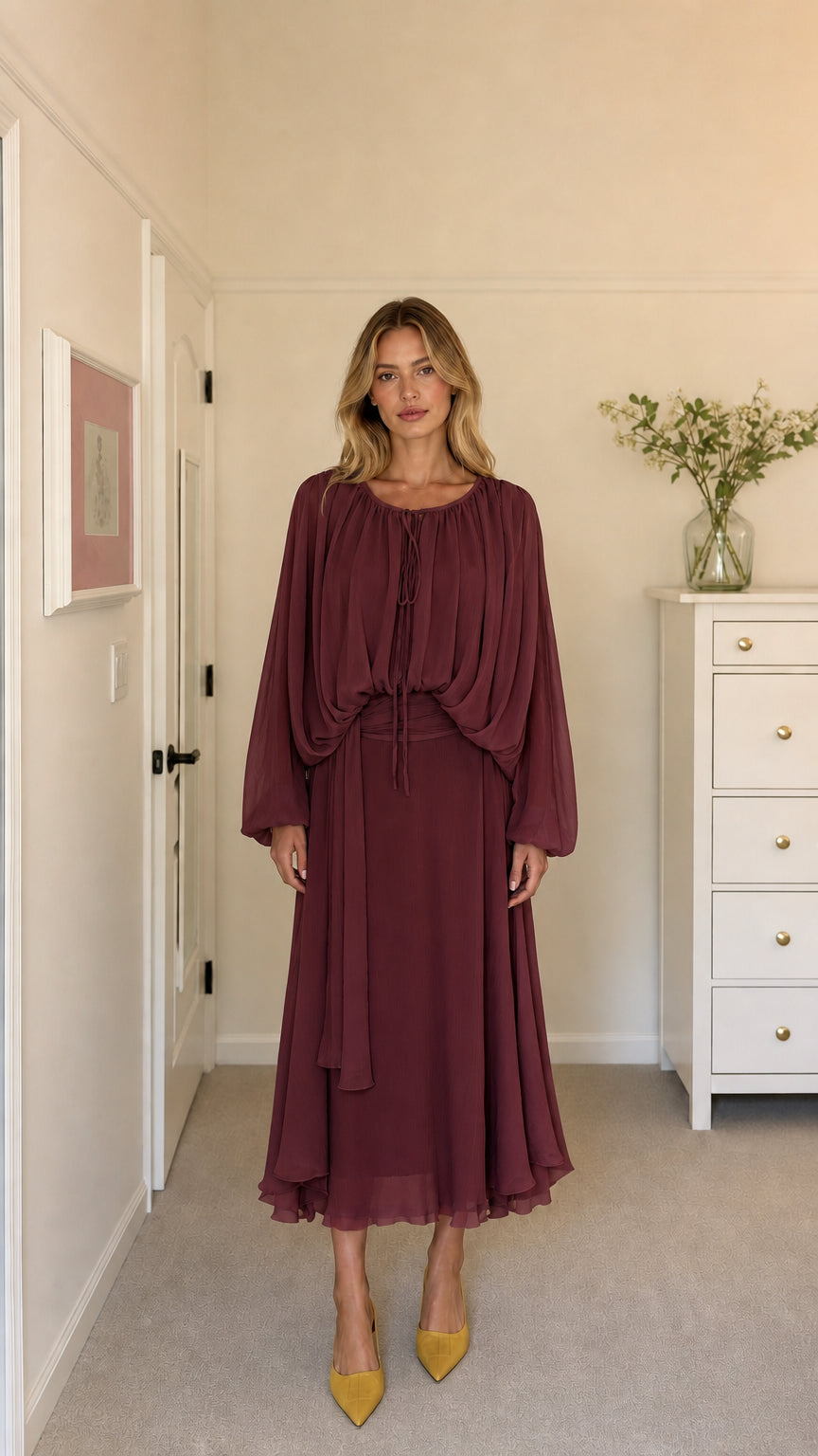 Model wearing burgundy long-sleeve pleated midi dress