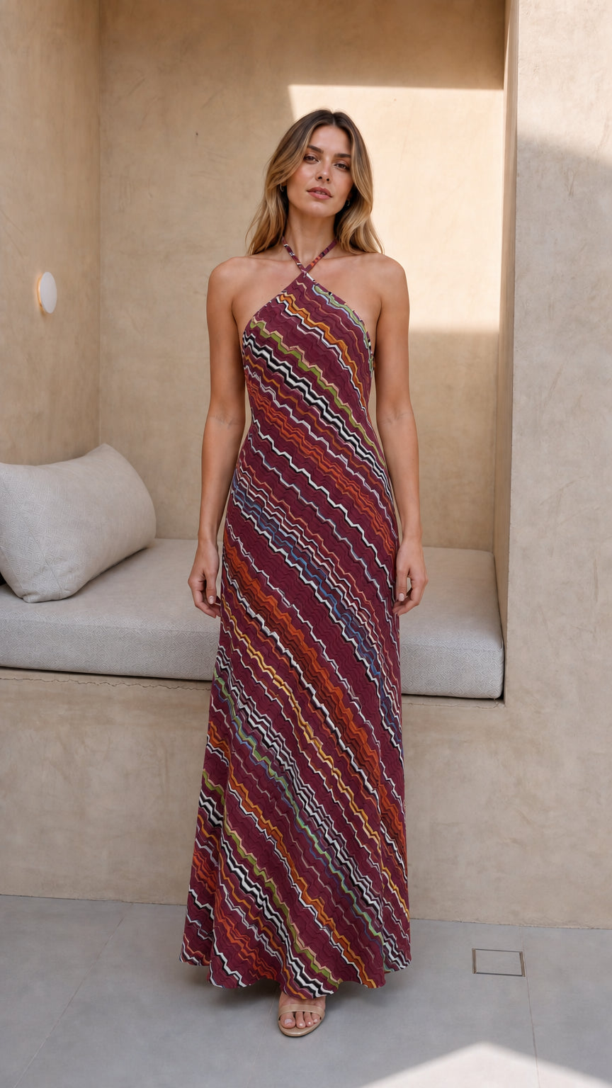 Model wearing burgundy-based chevron knit halter maxi dress