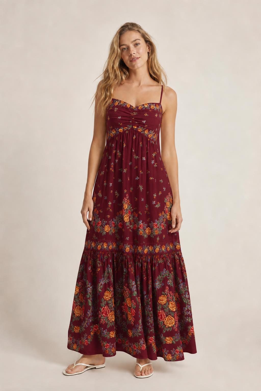 Front view of burgundy floral maxi dress on model