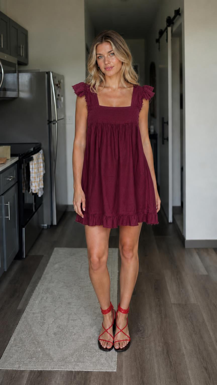 Front view of woman wearing burgundy square neck babydoll mini dress