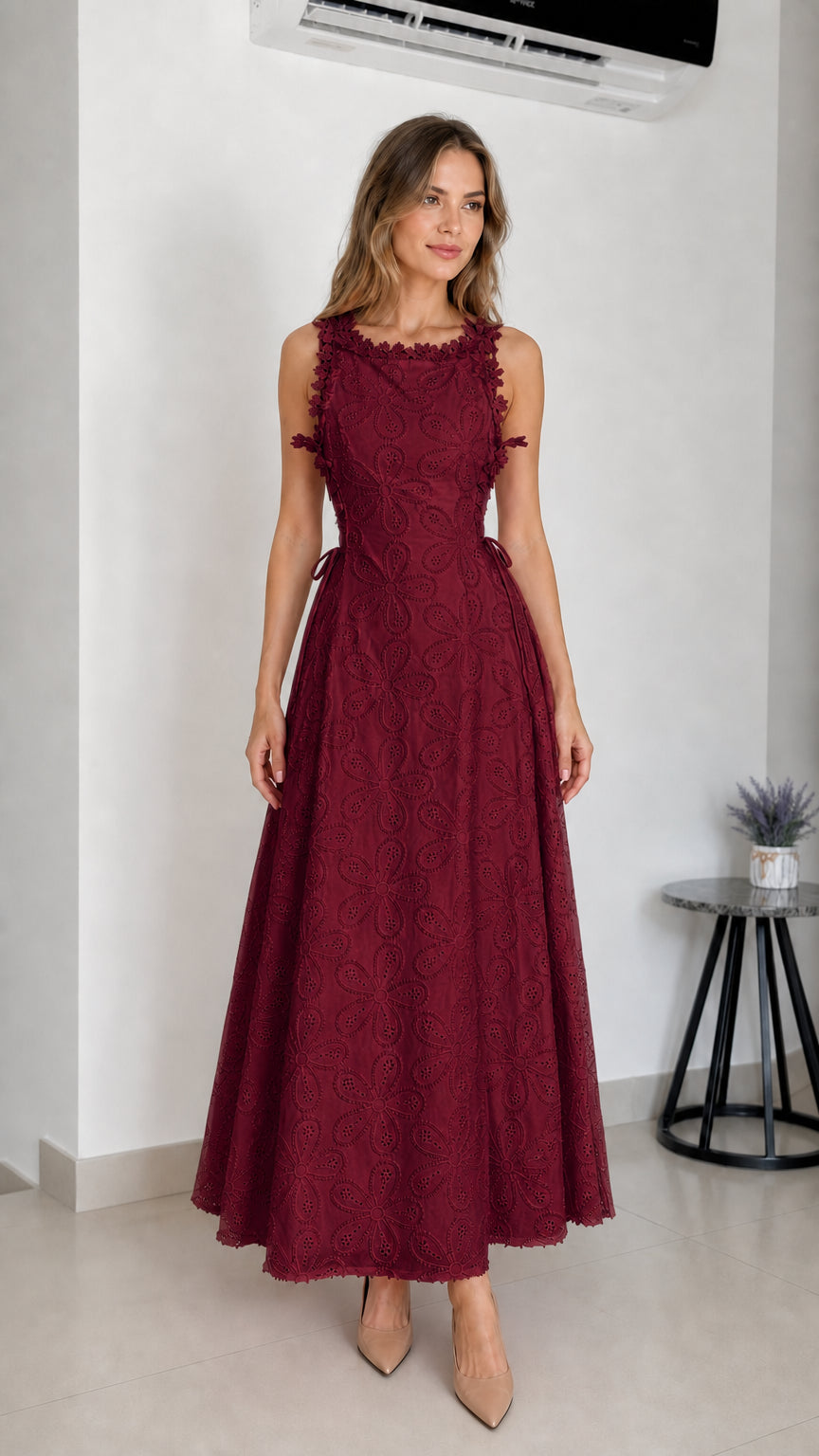 Model wearing burgundy embroidered eyelet maxi dress