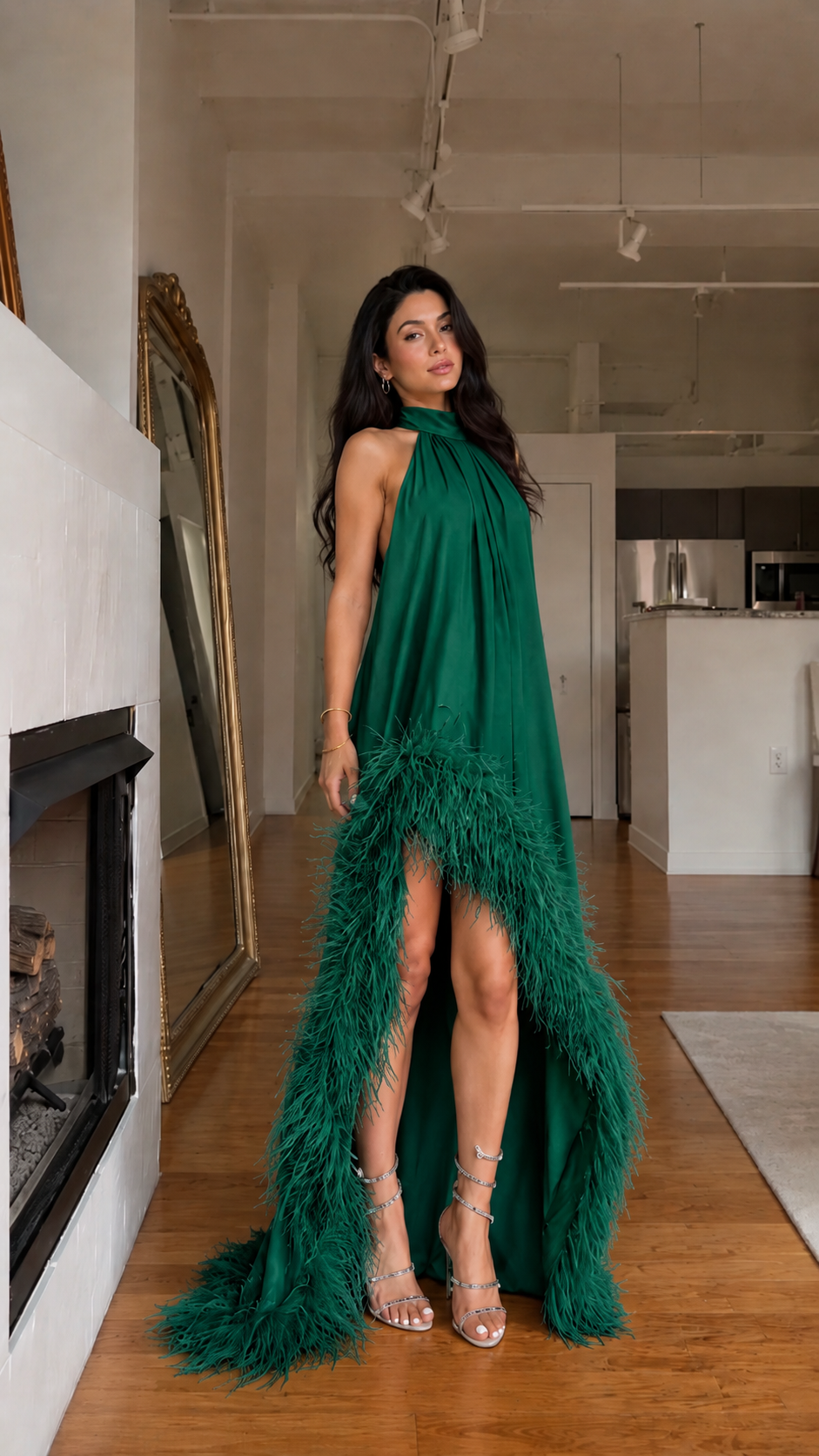 Front view of emerald halter high-low maxi dress with feather-trim detail