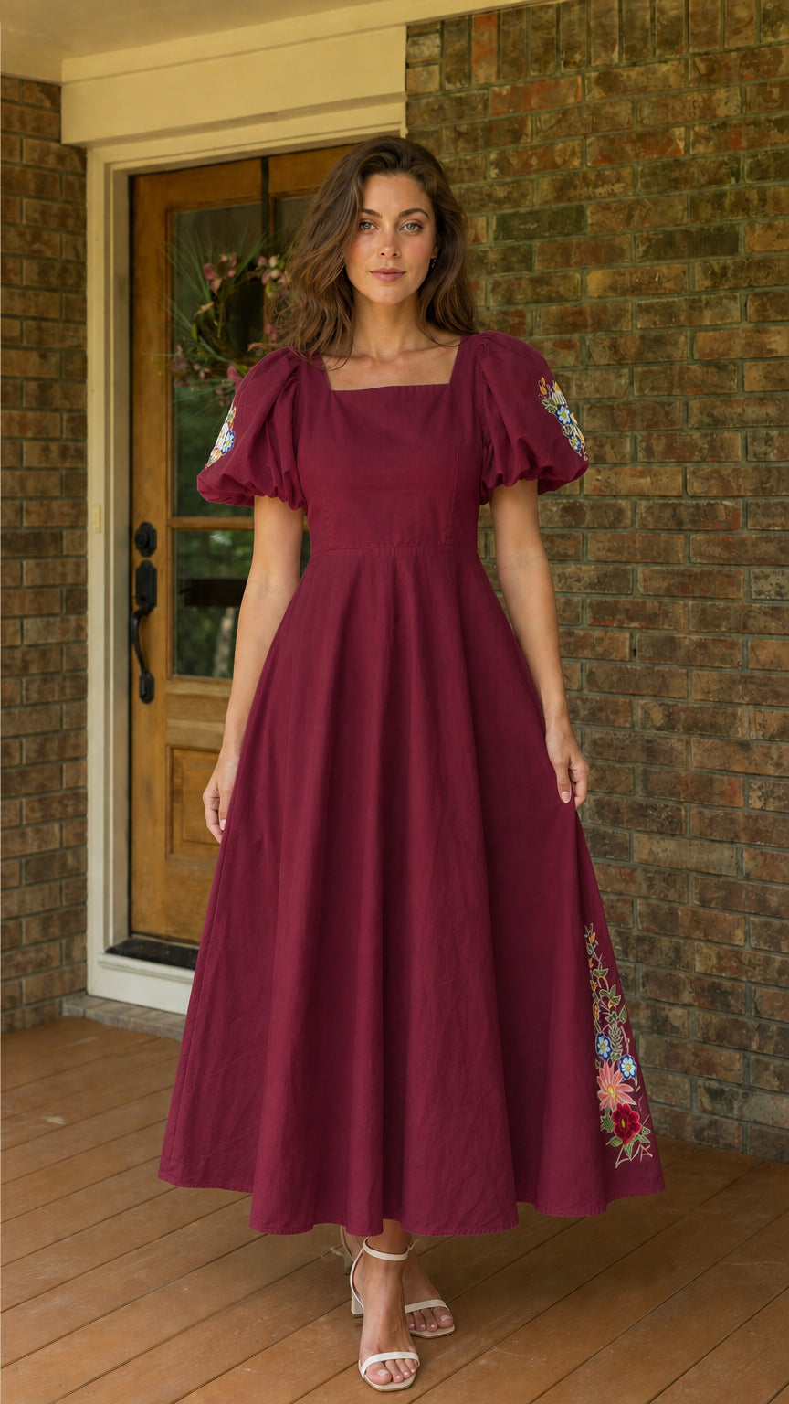 Front view of woman wearing burgundy embroidered puff sleeve midi dress