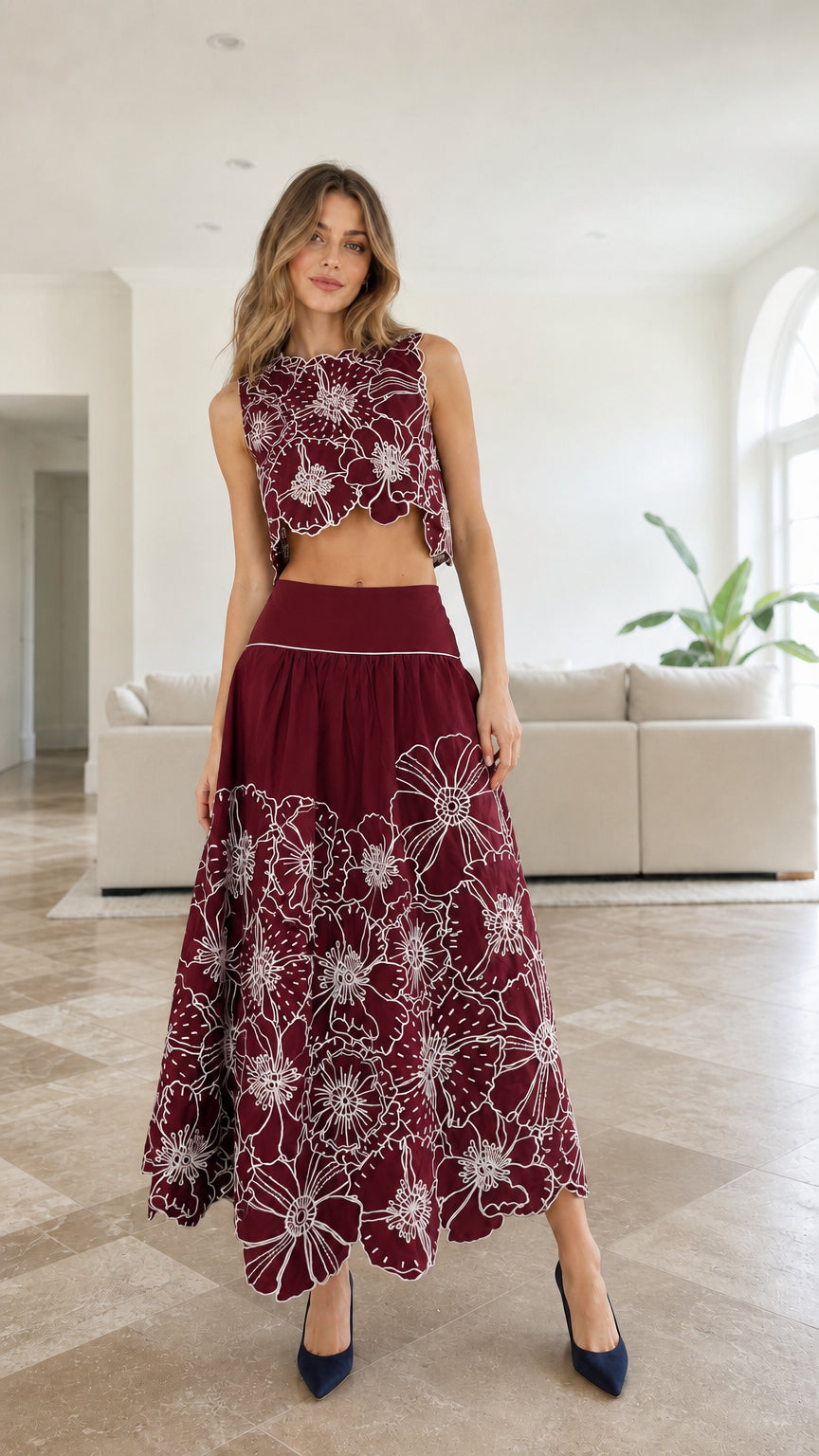 Model wearing burgundy embroidered floral crop top and maxi skirt set