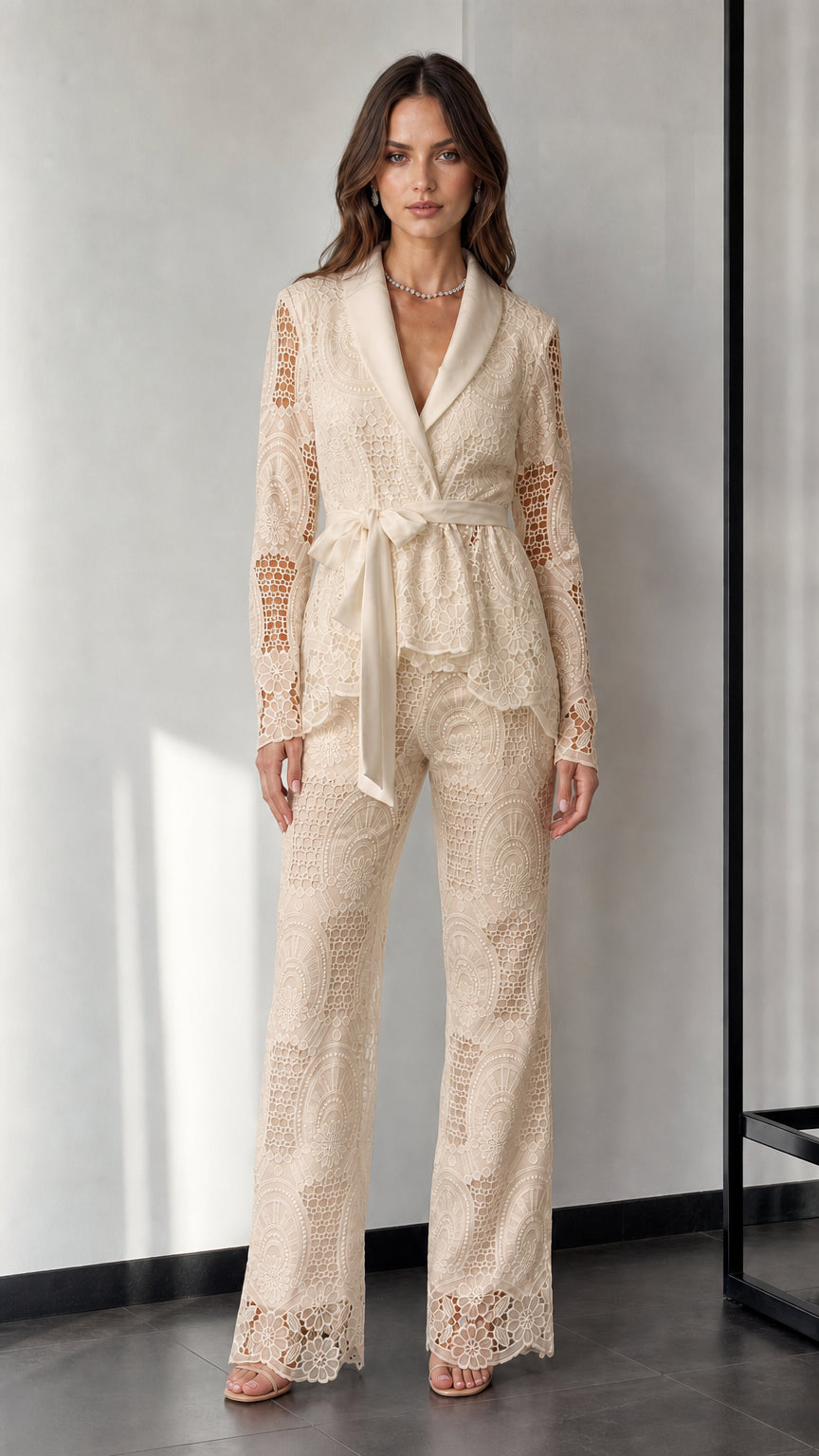 Woman wearing beige lace blazer and trousers set